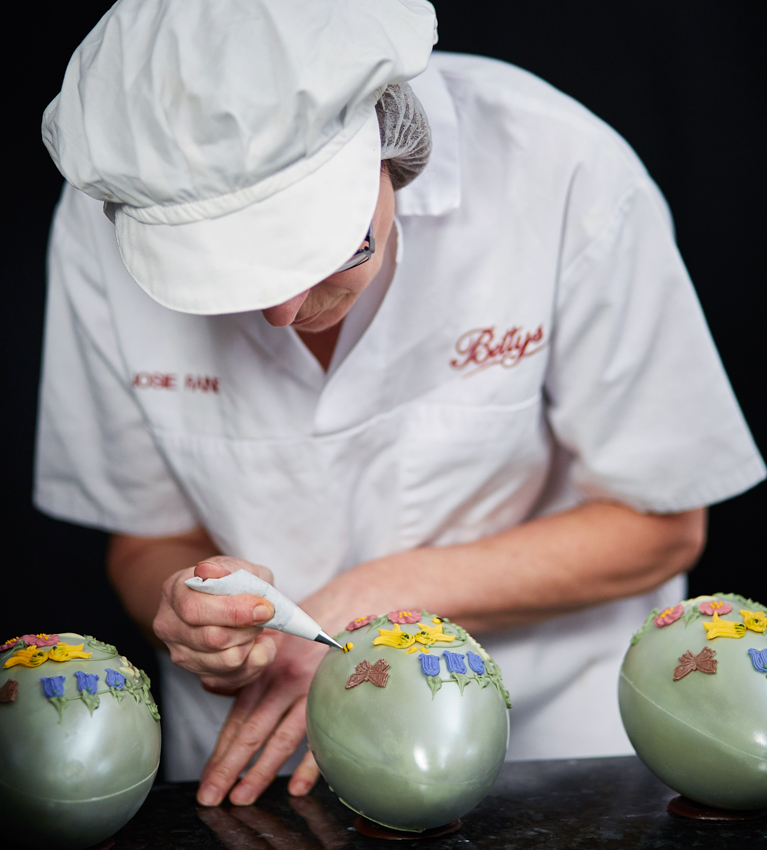 Josie adds some of the detailed piping work on a Spring Bloom Egg